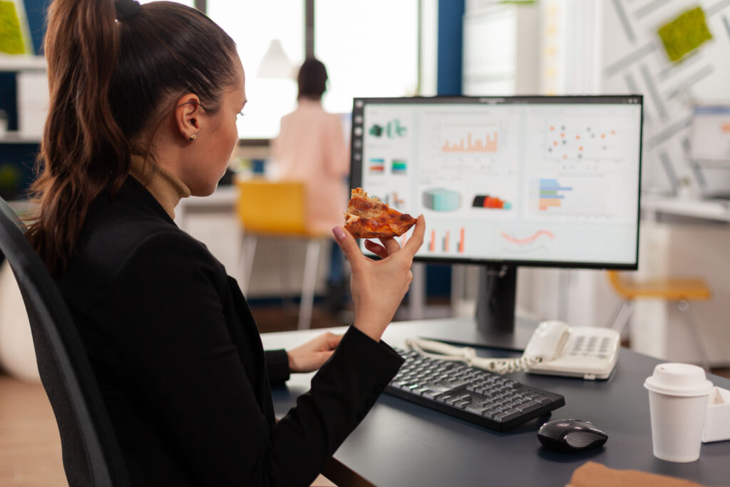 businesswoman enjoying food meal order in company office during takeout lunchtime break